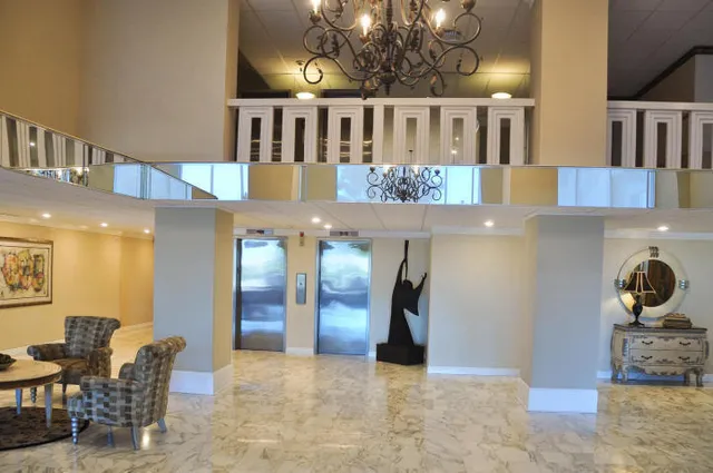 a view of a livingroom with furniture and staircase