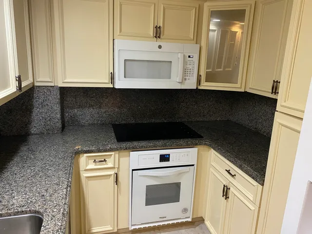 a stove top oven sitting inside of a kitchen