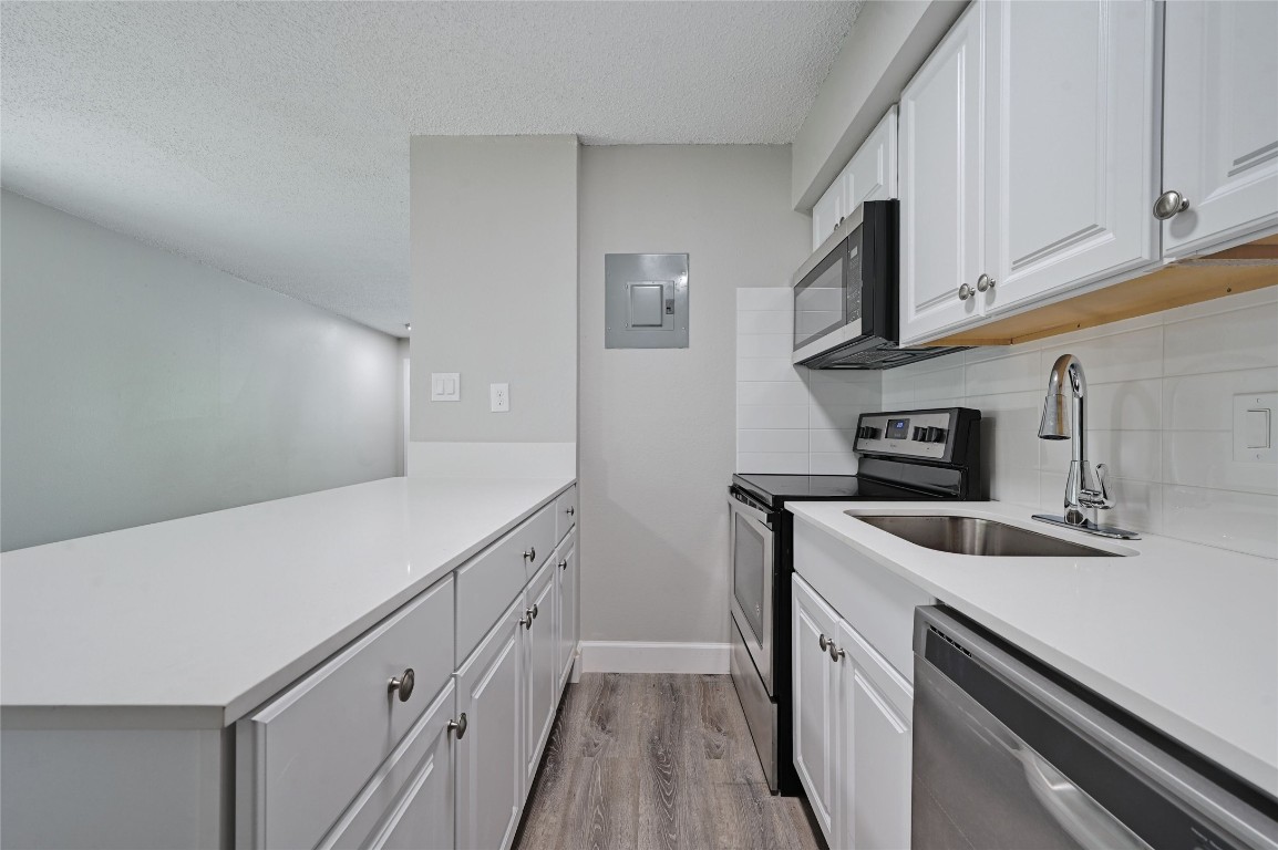 1200 Banister Lane, Unit 2 Austin, TX 78704 - Photo 11 of 14 a kitchen with stainless steel appliances granite countertop a sink and a refrigerator