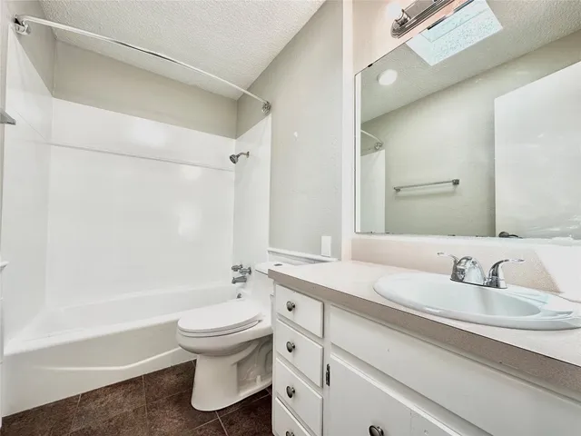 a bathroom with a sink a toilet and a bathtub