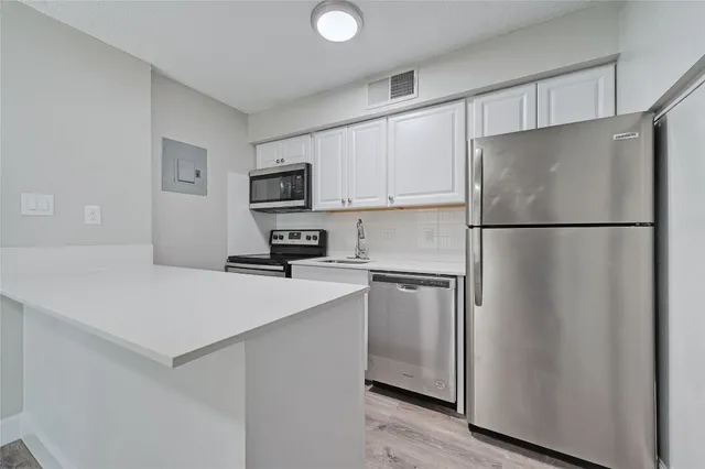 a white refrigerator freezer sitting in a kitchen