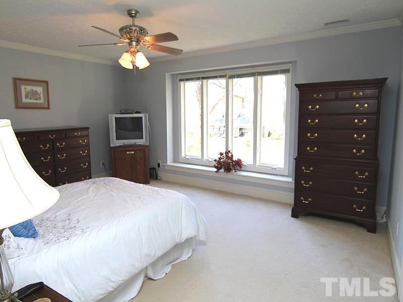 5016 Trail Ridge Drive Raleigh, NC 27613 - Photo 15 of 25 a spacious bedroom with a bed and a dresser