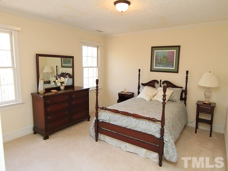 5016 Trail Ridge Drive Raleigh, NC 27613 - Photo 17 of 25 a bedroom with a bed and window