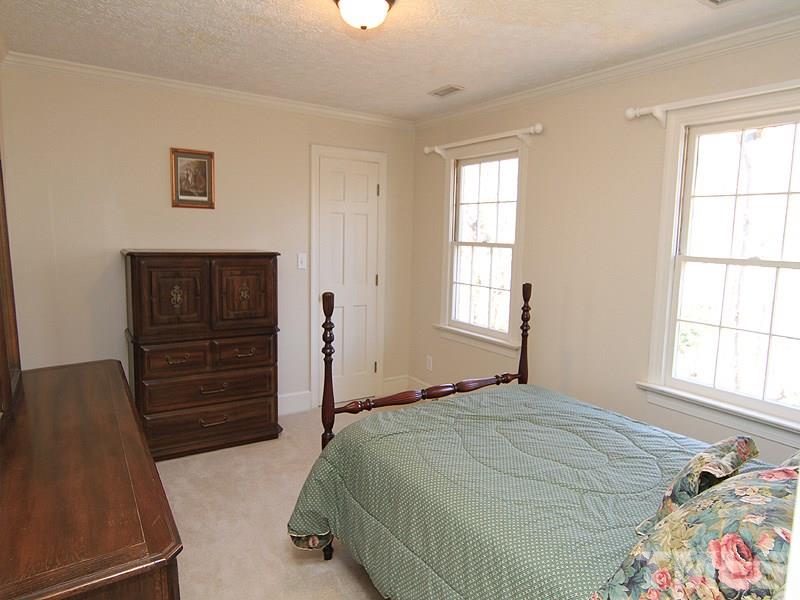 5016 Trail Ridge Drive Raleigh, NC 27613 - Photo 18 of 25 a bedroom with a bed and a window