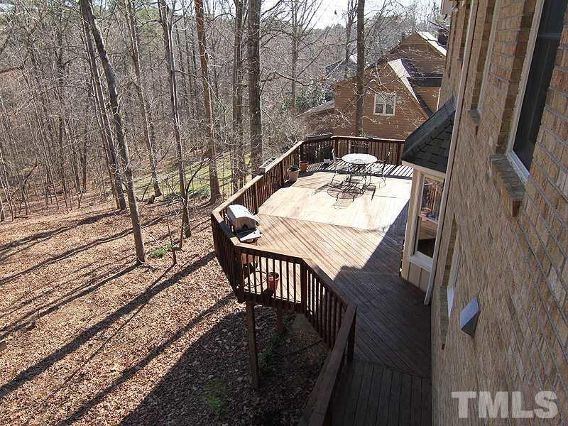 5016 Trail Ridge Drive Raleigh, NC 27613 - Photo 23 of 25 a view of a chairs and table on the deck