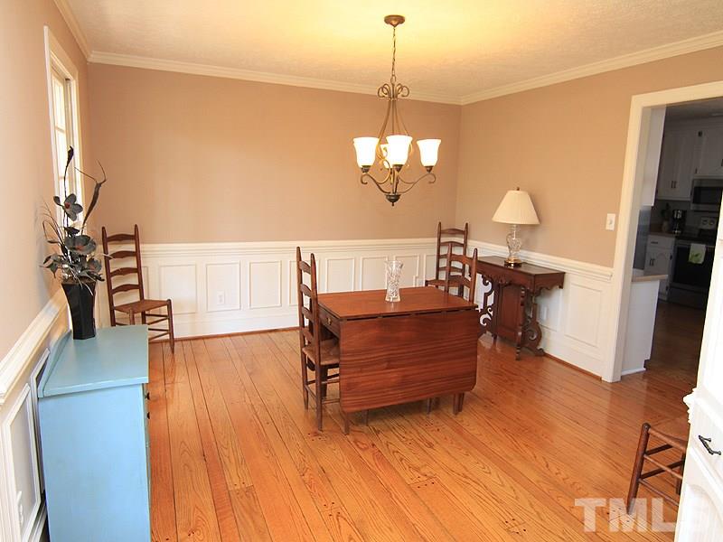 5016 Trail Ridge Drive Raleigh, NC 27613 - Photo 6 of 25 a living room with furniture and a chandelier