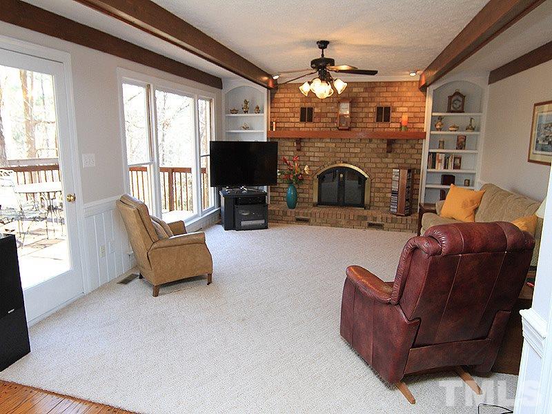 5016 Trail Ridge Drive Raleigh, NC 27613 - Photo 9 of 25 a living room with furniture flat screen tv and a fireplace