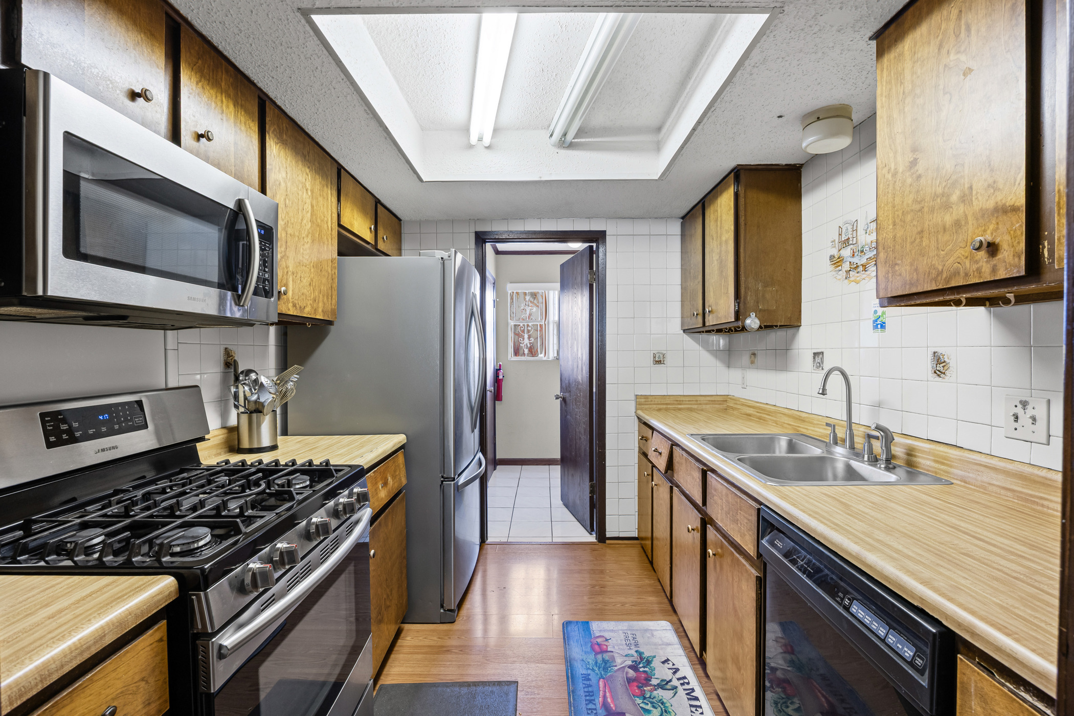 6300 Libyan Drive Austin, TX 78745 - Photo 14 of 35 a kitchen with stainless steel appliances granite countertop a sink stove and refrigerator