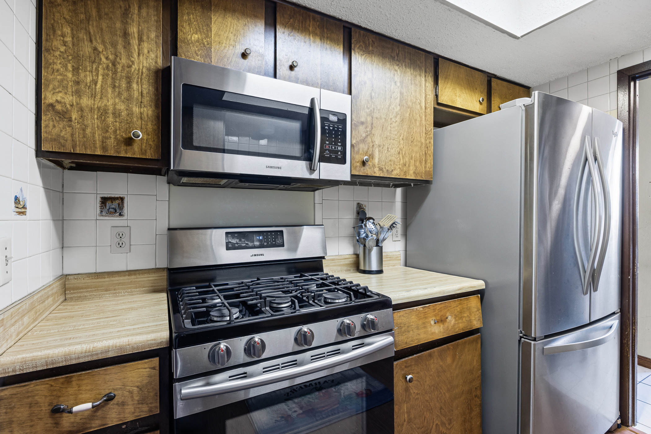 6300 Libyan Drive Austin, TX 78745 - Photo 16 of 35 a kitchen with stainless steel appliances granite countertop a refrigerator stove and microwave