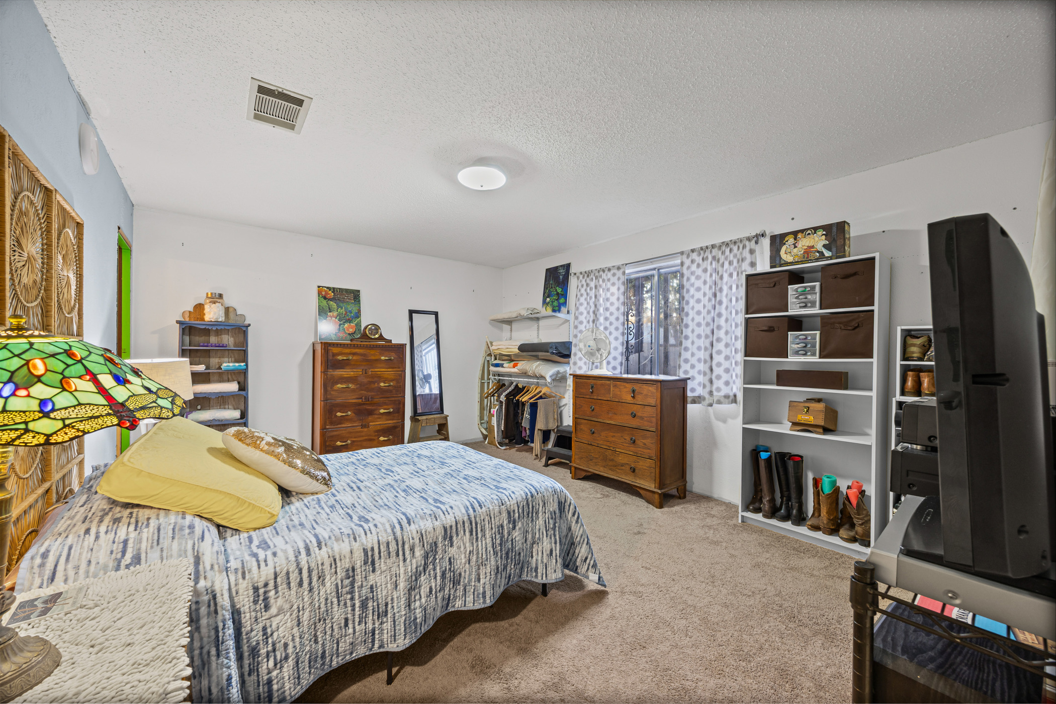 6300 Libyan Drive Austin, TX 78745 - Photo 19 of 35 a bedroom with a bed furniture and a flat tv screen