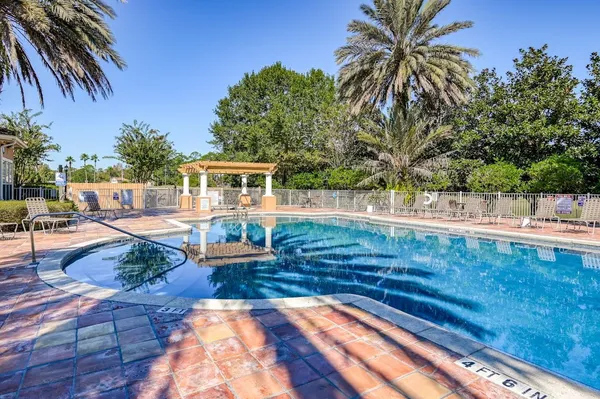 swimming pool view with a seating space