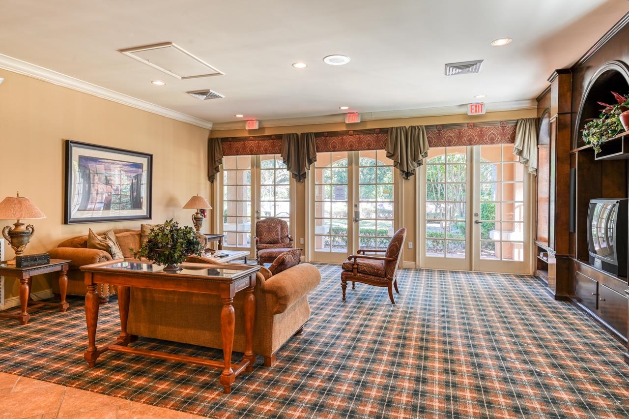 605 Fairway Drive, Unit 305 St. Augustine, FL 32084 - Photo 20 of 23 a living room with furniture rug and a flat screen tv