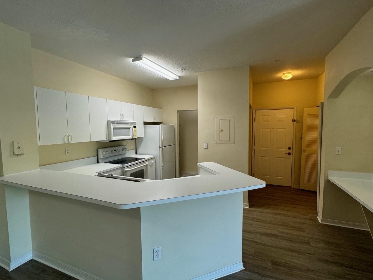 605 Fairway Drive, Unit 305 St. Augustine, FL 32084 - Photo 3 of 23 a kitchen with a appliances a sink and cabinets