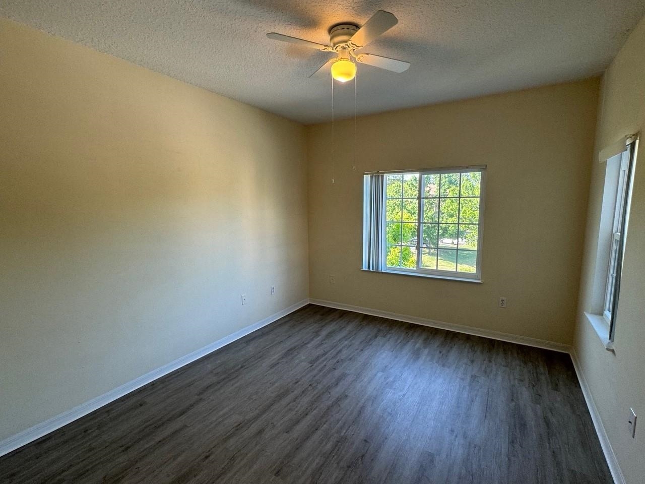 605 Fairway Drive, Unit 305 St. Augustine, FL 32084 - Photo 4 of 23 a view of an empty room with window and wooden floor