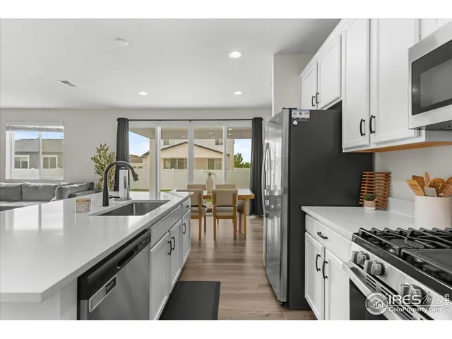 a kitchen with stainless steel appliances a refrigerator and a stove top oven