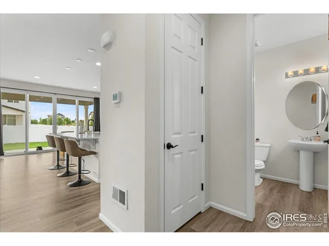 a living room with stainless steel appliances kitchen island a table and chairs