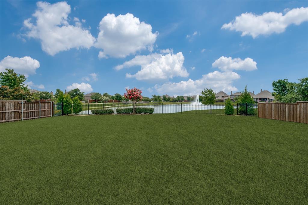 7821 Kentmere The Colony, TX 75056 - Photo 26 of 40 An exceptional quarter-acre backyard offers endless possibilities for a resort-style pool, outdoor entertaining, or simply enjoying the expansive green space. Backing to a peaceful neighborhood canal with a beautiful fountain, this premium lot provides tranquil water views and a picturesque setting that's rarely available.