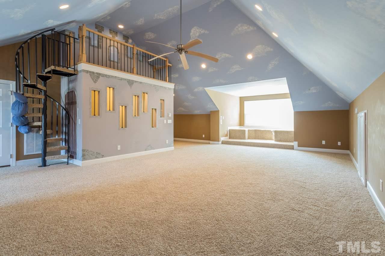 12319 Canolder Street Raleigh, NC 27614 - Photo 12 of 23 One of two bonus room. This room has a stage built above the stairs and another area with a dress up closet.