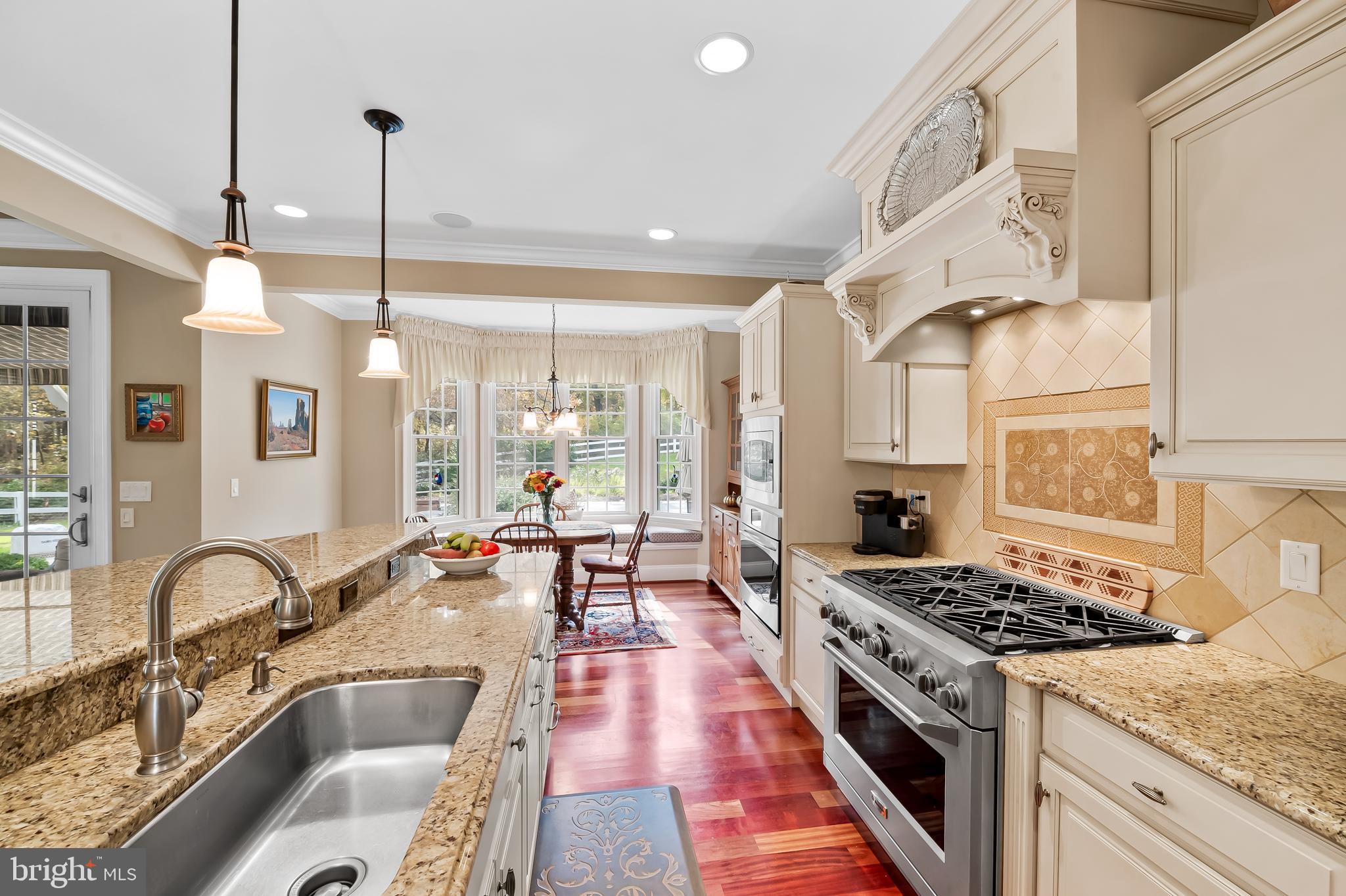 2049 Corbett Road Monkton, MD 21111 - Photo 12 of 66 a kitchen with stove a sink a counter space and dining table