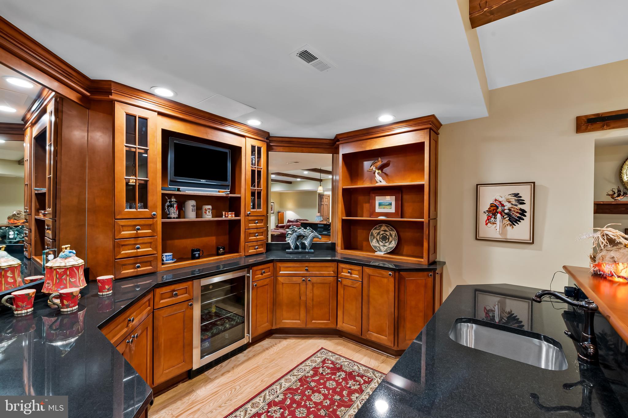 2049 Corbett Road Monkton, MD 21111 - Photo 51 of 66 a kitchen with stainless steel appliances granite countertop a sink and wooden cabinets