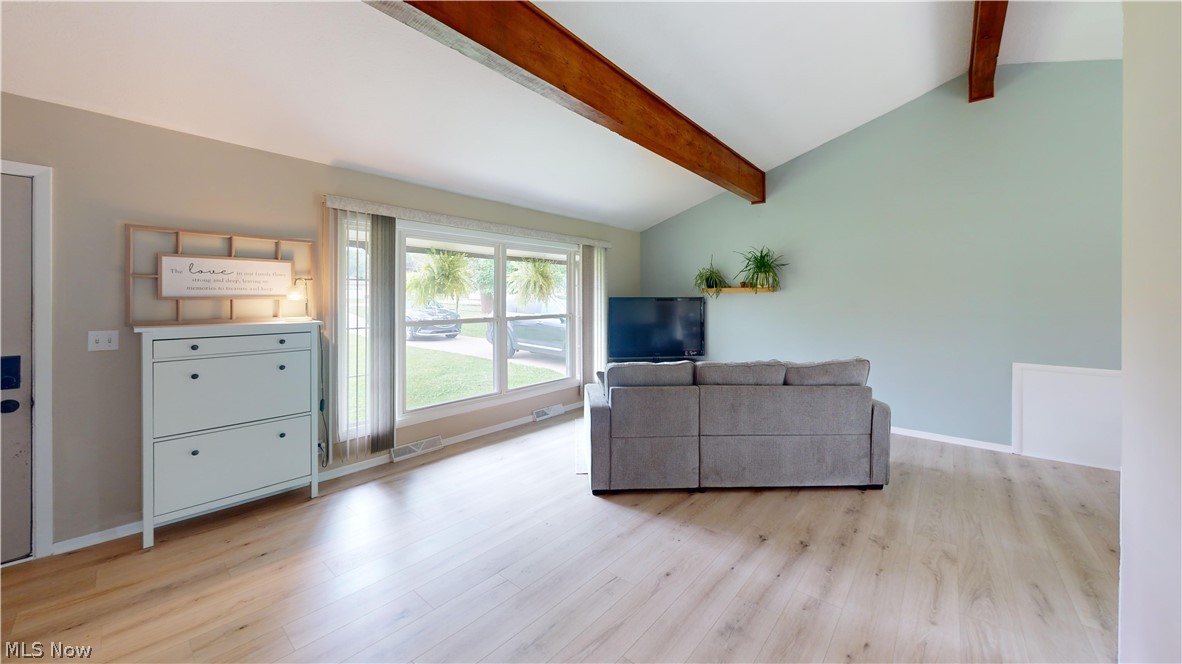 9260 Avery Road Broadview Heights, OH 44147 - Photo 8 of 43 Vaulted ceiling with exposed wood beams, wood-finish flooring