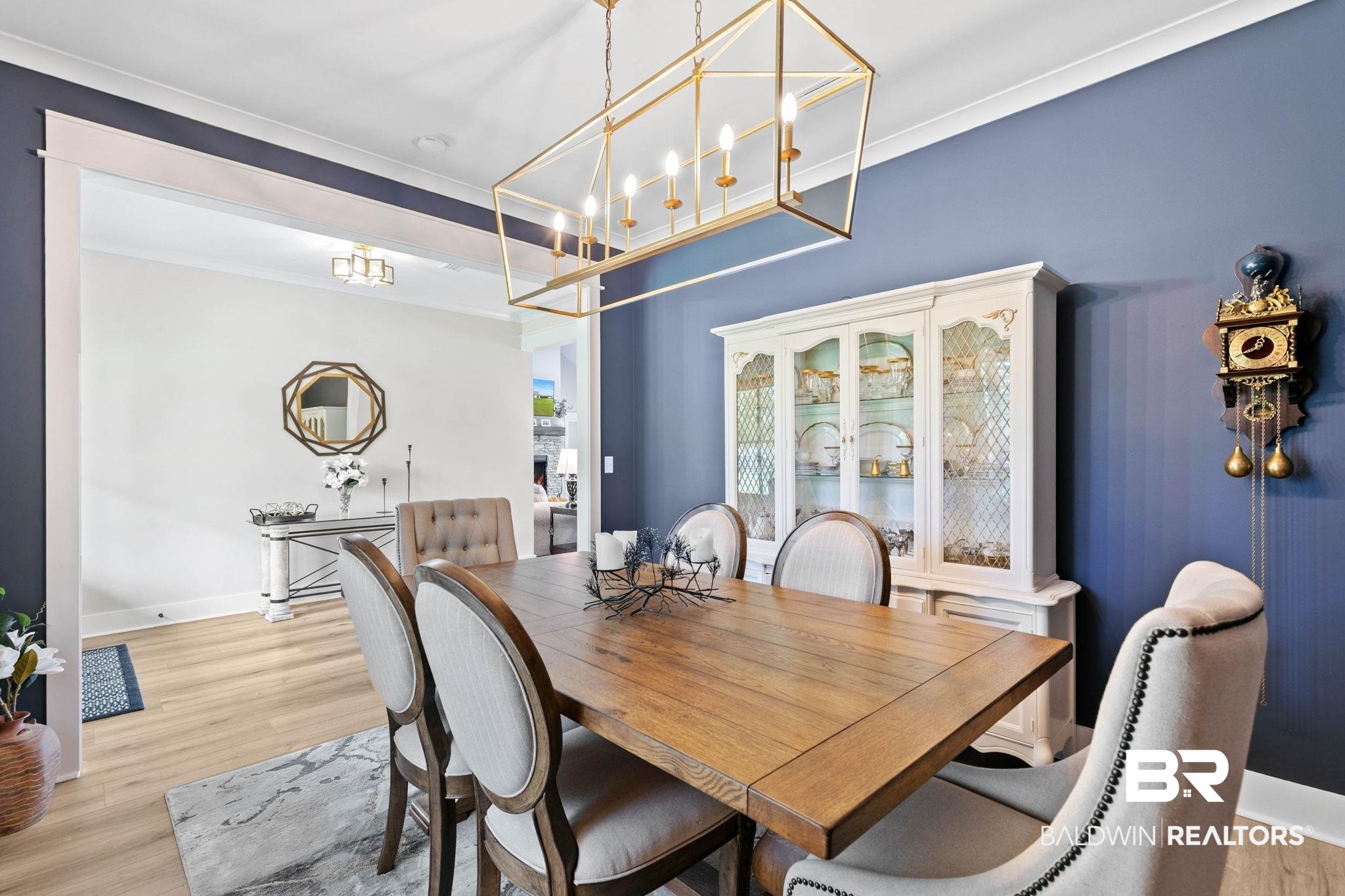 2029 George Lee Road Repton, AL 36475 - Photo 10 of 58 Dining area featuring a rectangular wood dining table, a linear brass chandelier, and wood-finish flooring