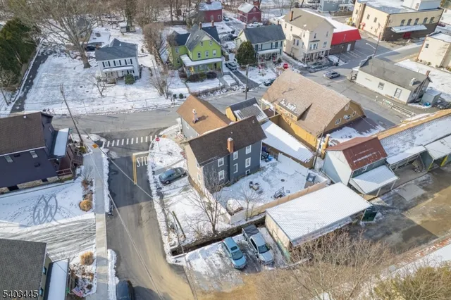 an aerial view of residential house with outdoor space and seating