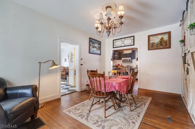a view of a dining room with furniture and chandelier