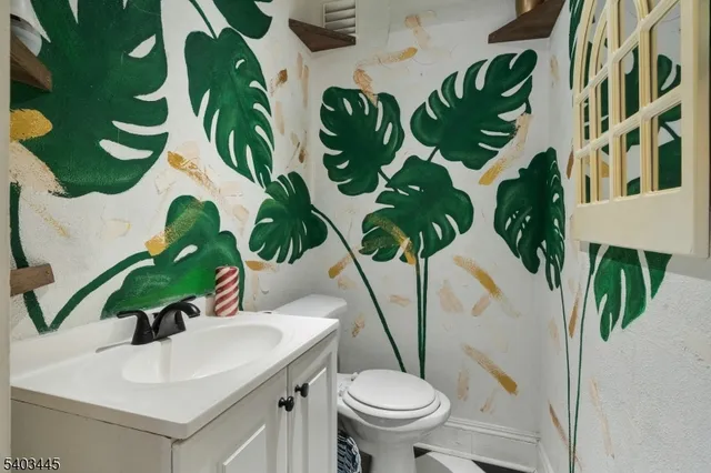 a vase of flowers sitting on a table with chairs