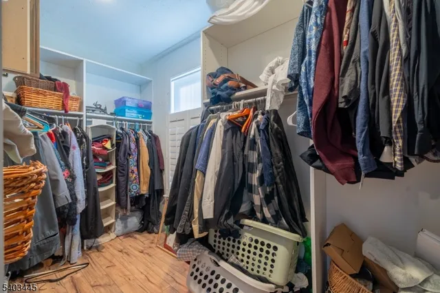 a view of walk in closet with clothes