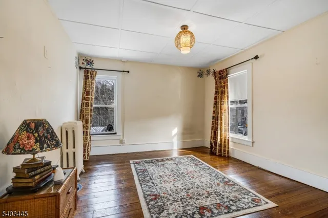 a view of a livingroom with wooden floor and a window