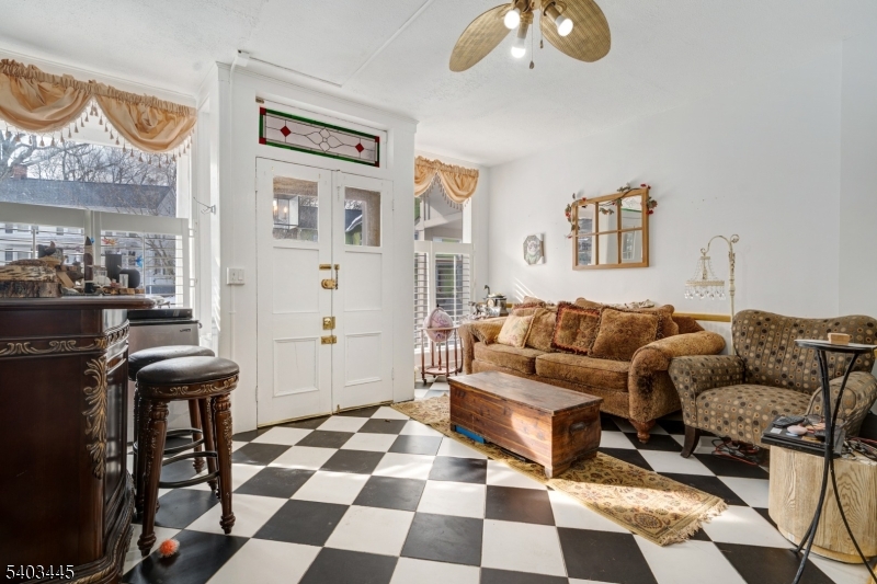 44 Main Street Califon, NJ 07830 - Photo 39 of 43 a living room with couches and a dining table with wooden floor