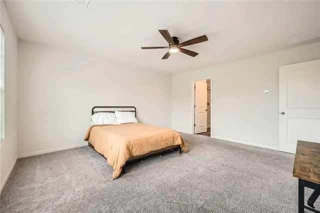 a bedroom with a bed and chair