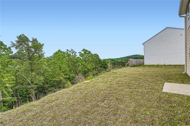 a view of a yard with an trees in front of it