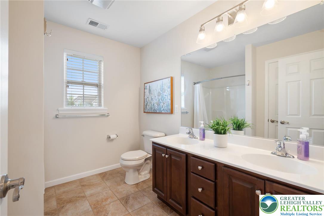 208 East Dell Road Bath, PA 18014 - Photo 27 of 40 a bathroom with a sink double vanity and a toilet