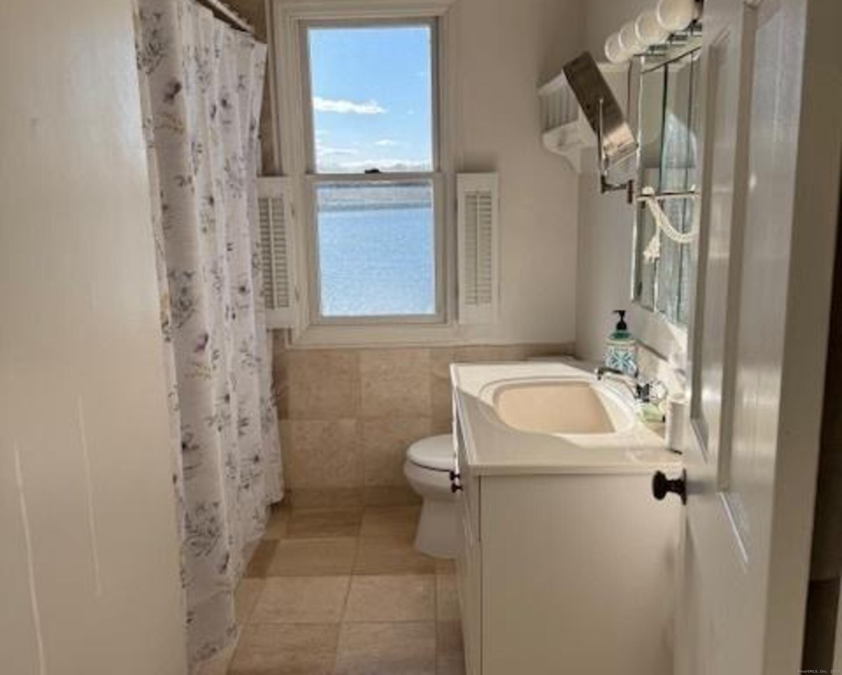 123 Seneca Drive Groton, CT 06340 - Photo 23 of 25 a bathroom with a sink a toilet and shower