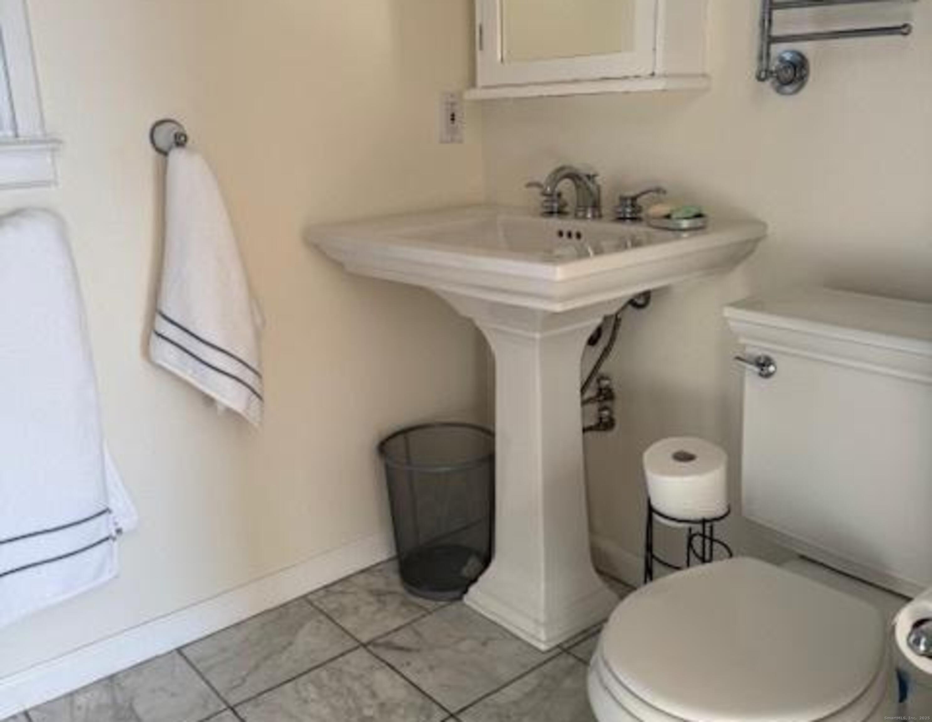 123 Seneca Drive Groton, CT 06340 - Photo 24 of 25 a white toilet sitting next to a bathroom sink