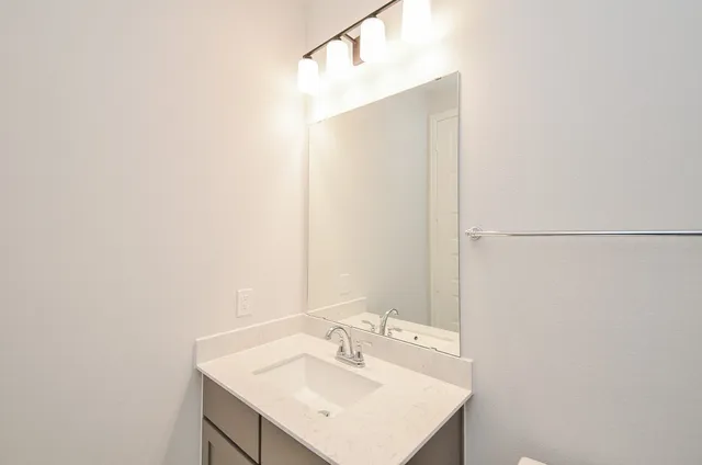 a bathroom with a sink double vanity granite tub shower and a mirror