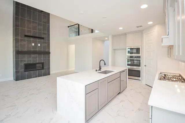 a large white kitchen with a large window