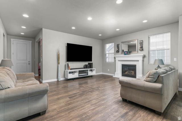 5686 Duke Lane Tooele, UT 84074 - Photo 27 of 38 Living area with wood finished floors, recessed lighting, and a glass covered fireplace