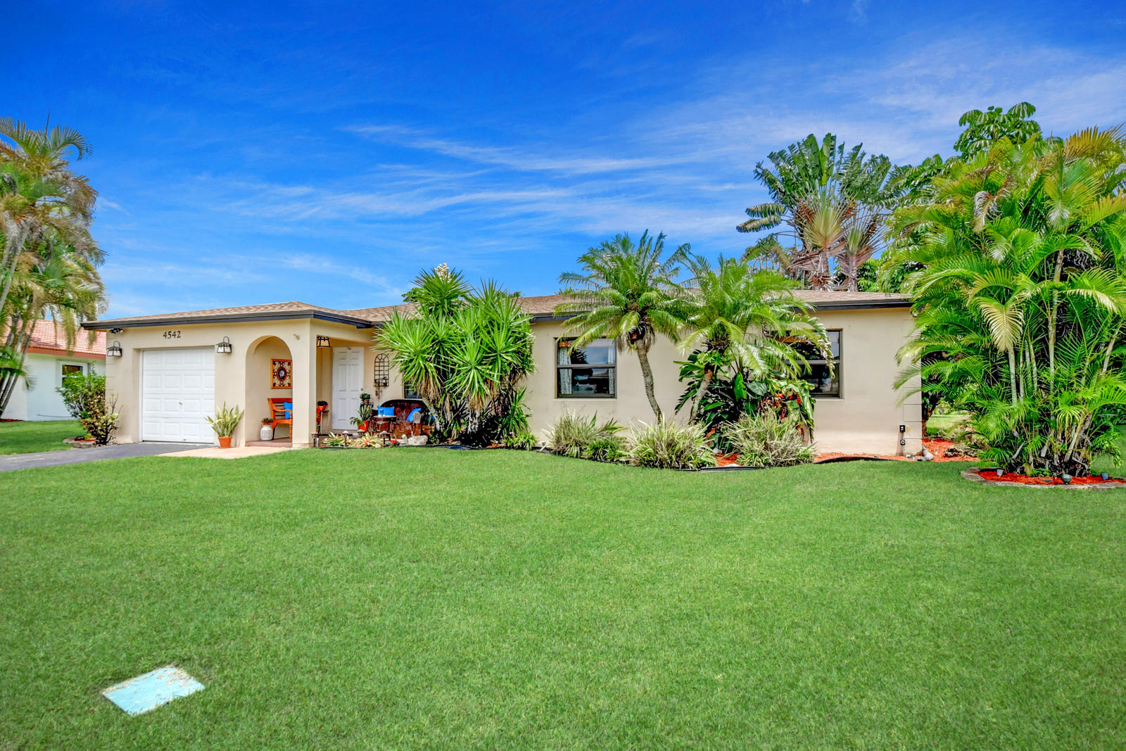 4542 Avalon Street Boca Raton, FL 33428 - Photo 1 of 51 a front view of a house with garden