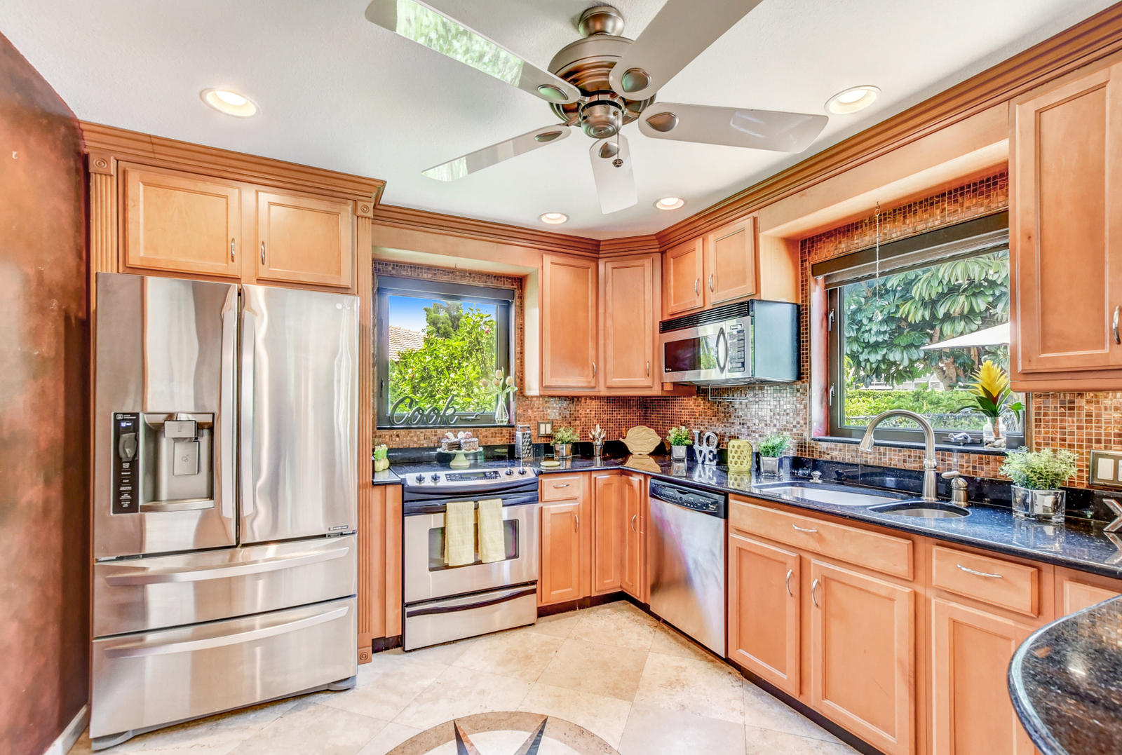 4542 Avalon Street Boca Raton, FL 33428 - Photo 15 of 51 a kitchen with stainless steel appliances a sink cabinets and large window