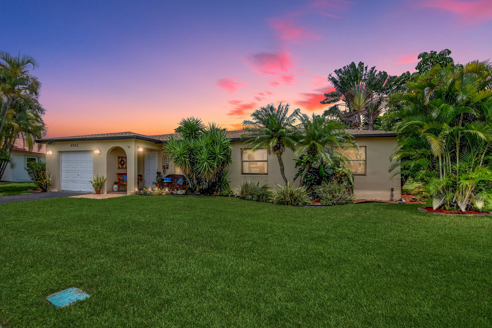 4542 Avalon Street Boca Raton, FL 33428 - Photo 2 of 51 a front view of a house with a garden