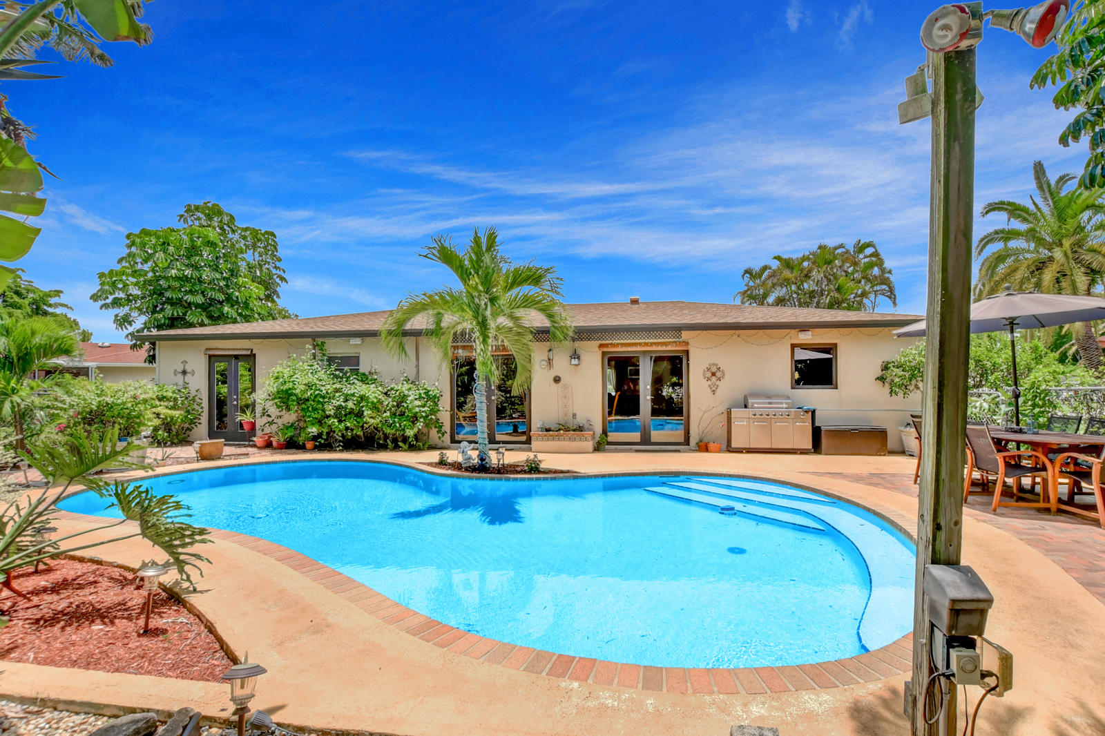 4542 Avalon Street Boca Raton, FL 33428 - Photo 30 of 51 a view of a house with swimming pool and sitting area