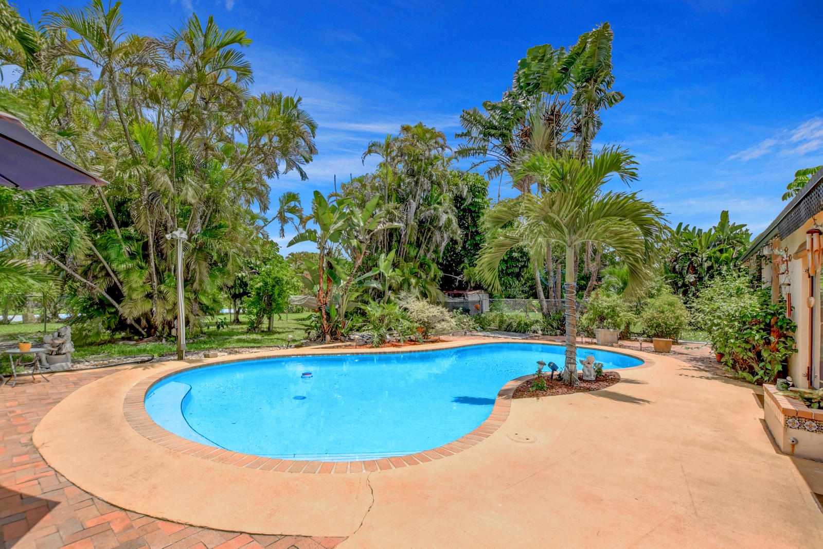 4542 Avalon Street Boca Raton, FL 33428 - Photo 32 of 51 a view of a swimming pool with an outdoor space