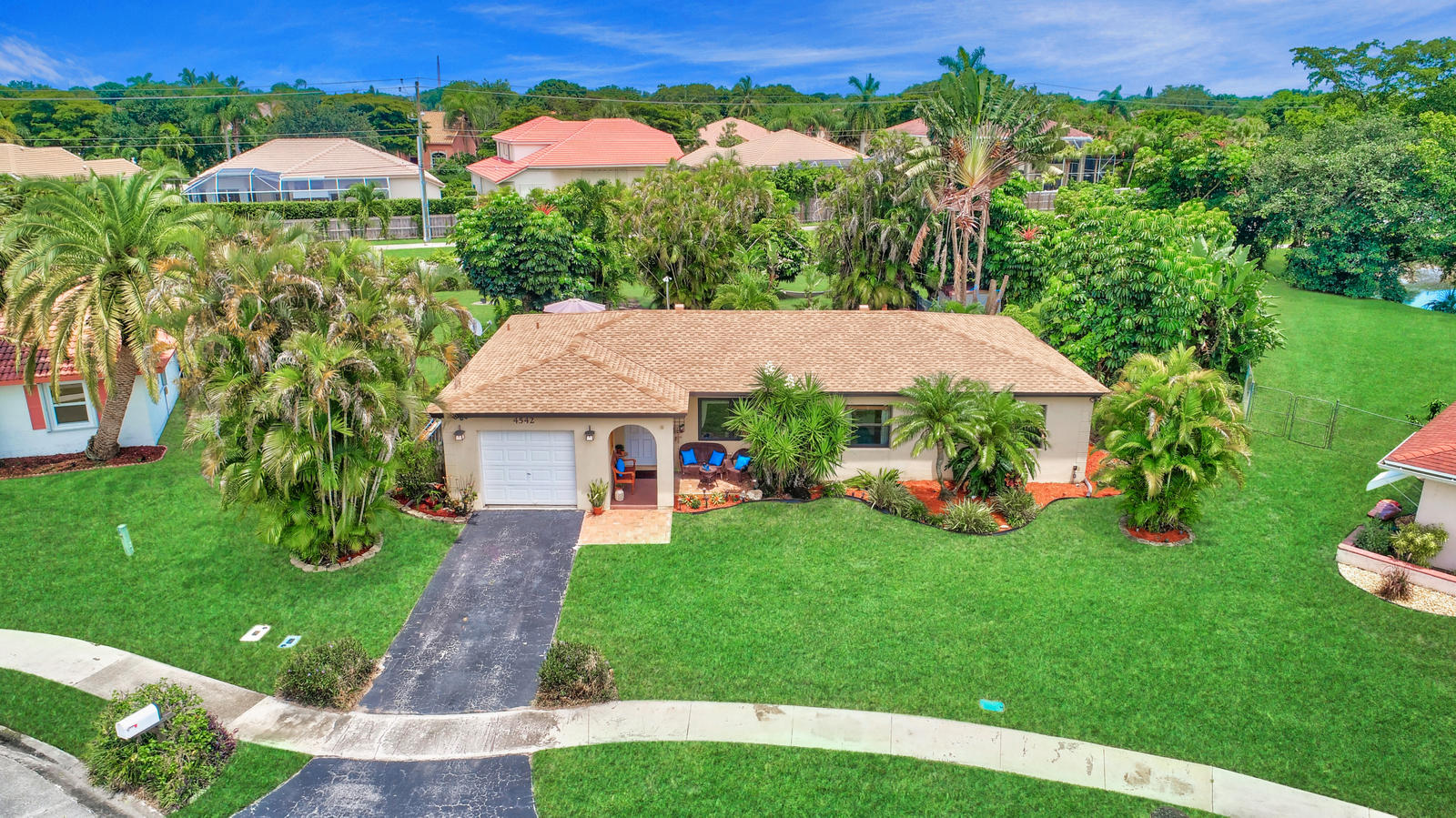 4542 Avalon Street Boca Raton, FL 33428 - Photo 49 of 51 a view of a house with garden and a table