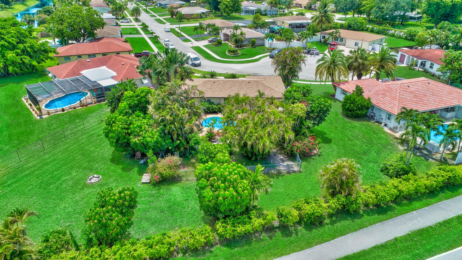 4542 Avalon Street Boca Raton, FL 33428 - Photo 6 of 51 an aerial view of residential houses with outdoor space and trees all around