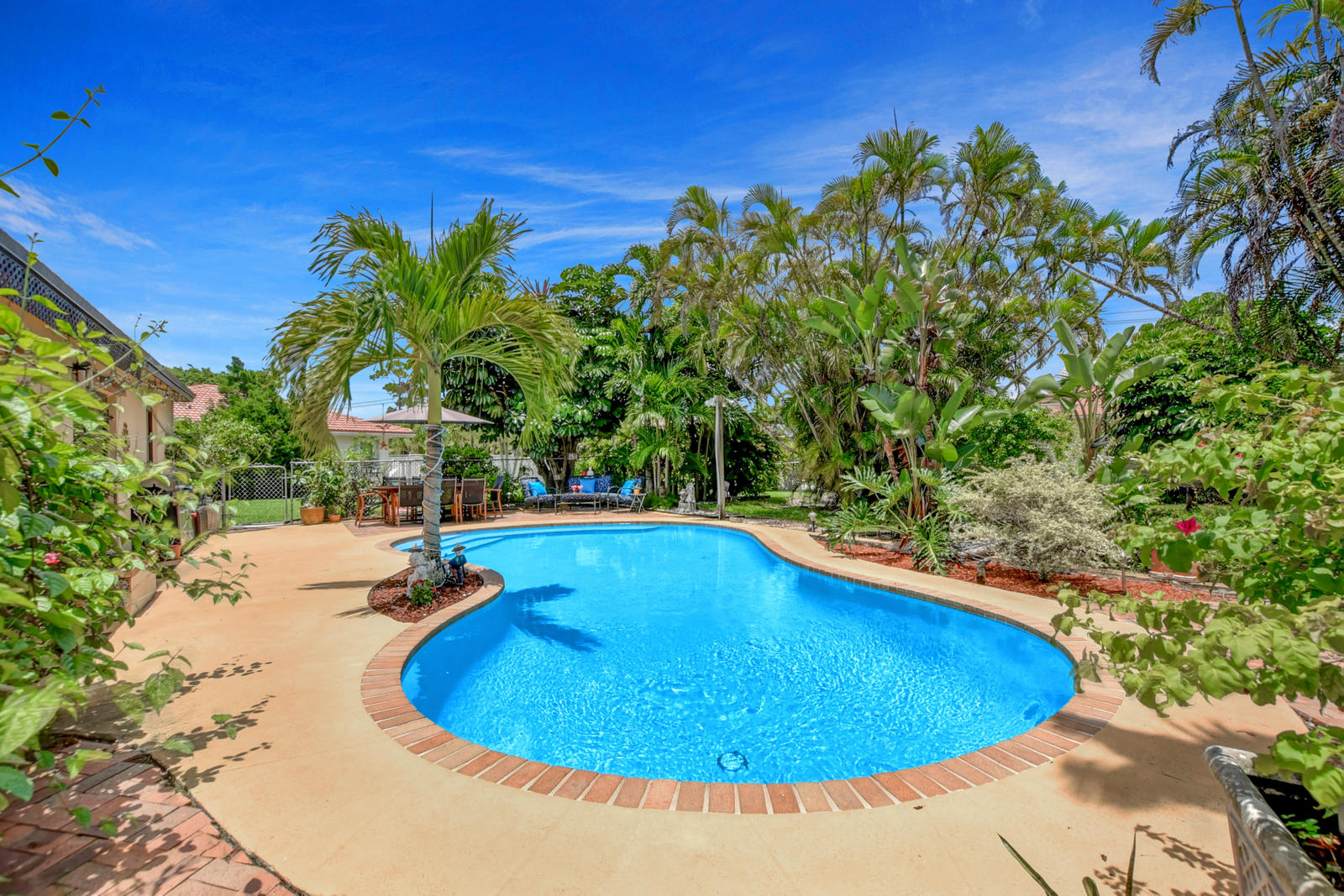 4542 Avalon Street Boca Raton, FL 33428 - Photo 7 of 51 a view of a swimming pool with an outdoor space and seating area