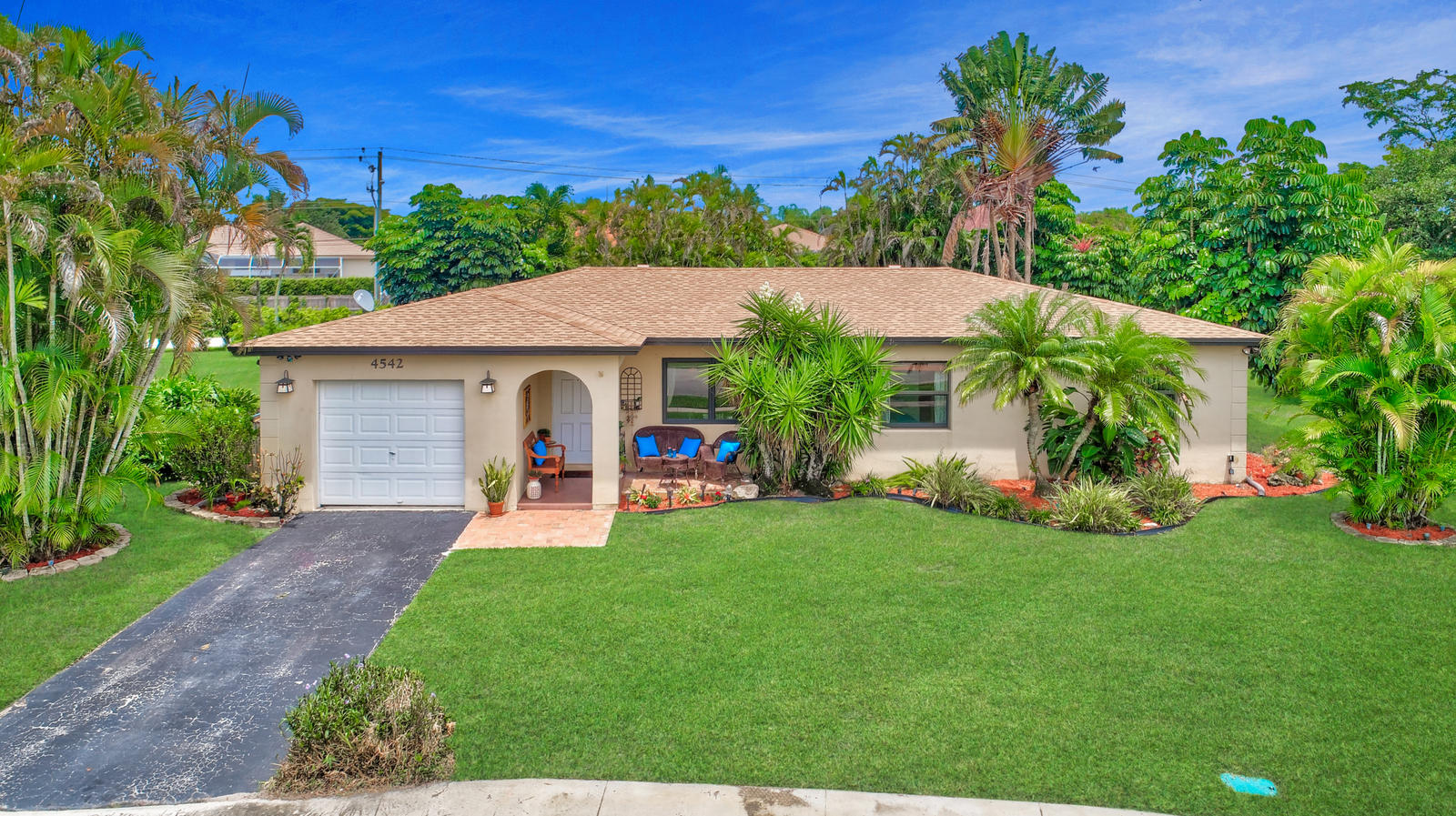 4542 Avalon Street Boca Raton, FL 33428 - Photo 9 of 51 a front view of a house with garden