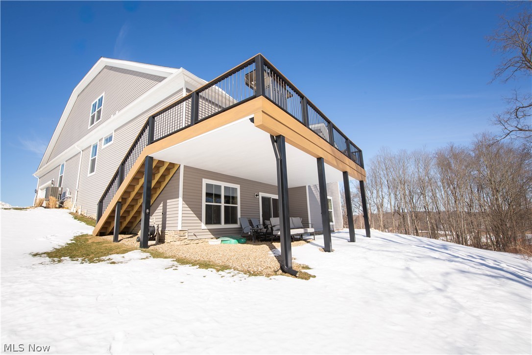 150 Seamore Road Aurora, OH 44202 - Photo 48 of 50 Snow covered house with a wooden deck and a patio